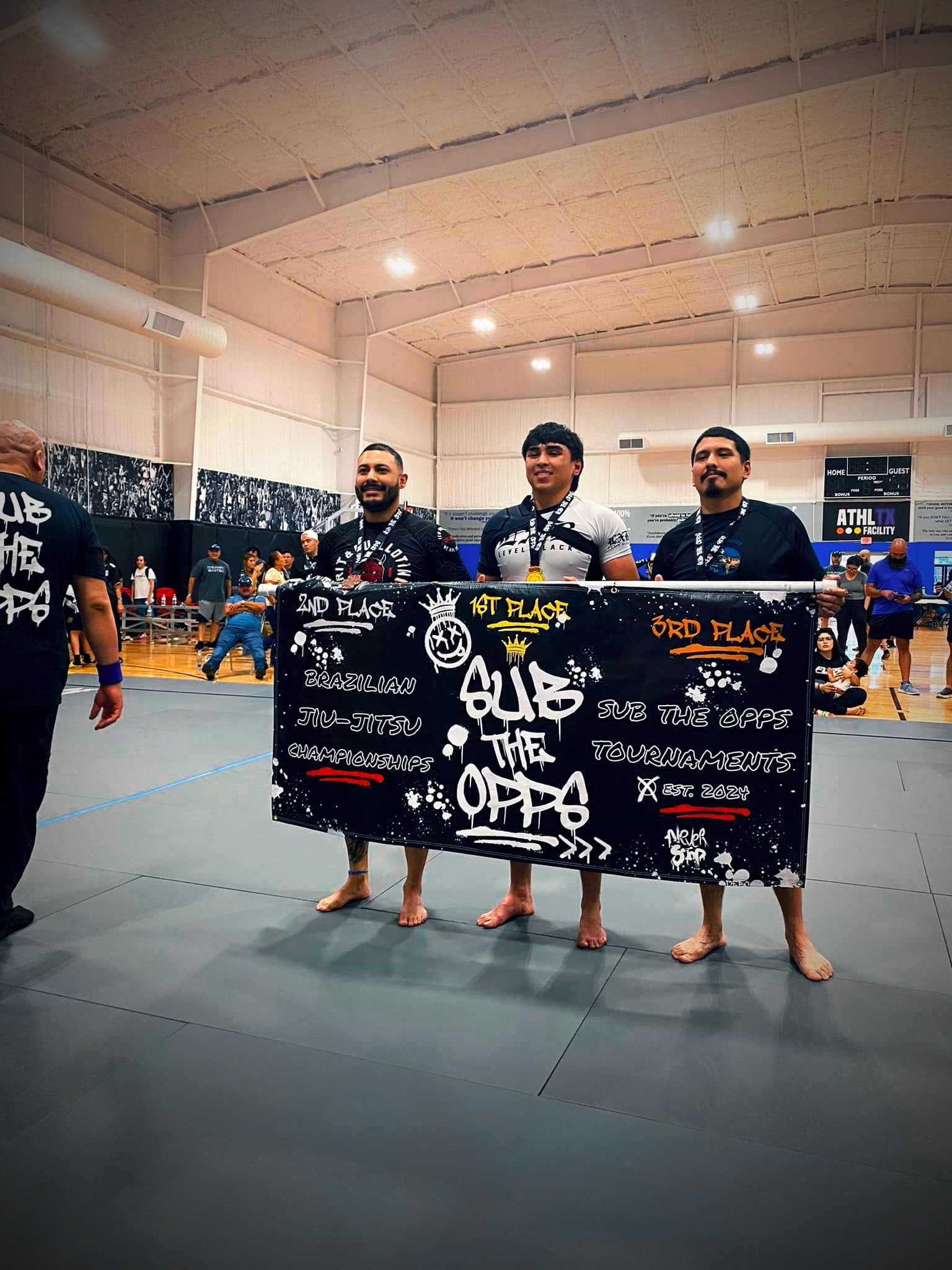 The competition team holds the Sub The Opps tournament banner