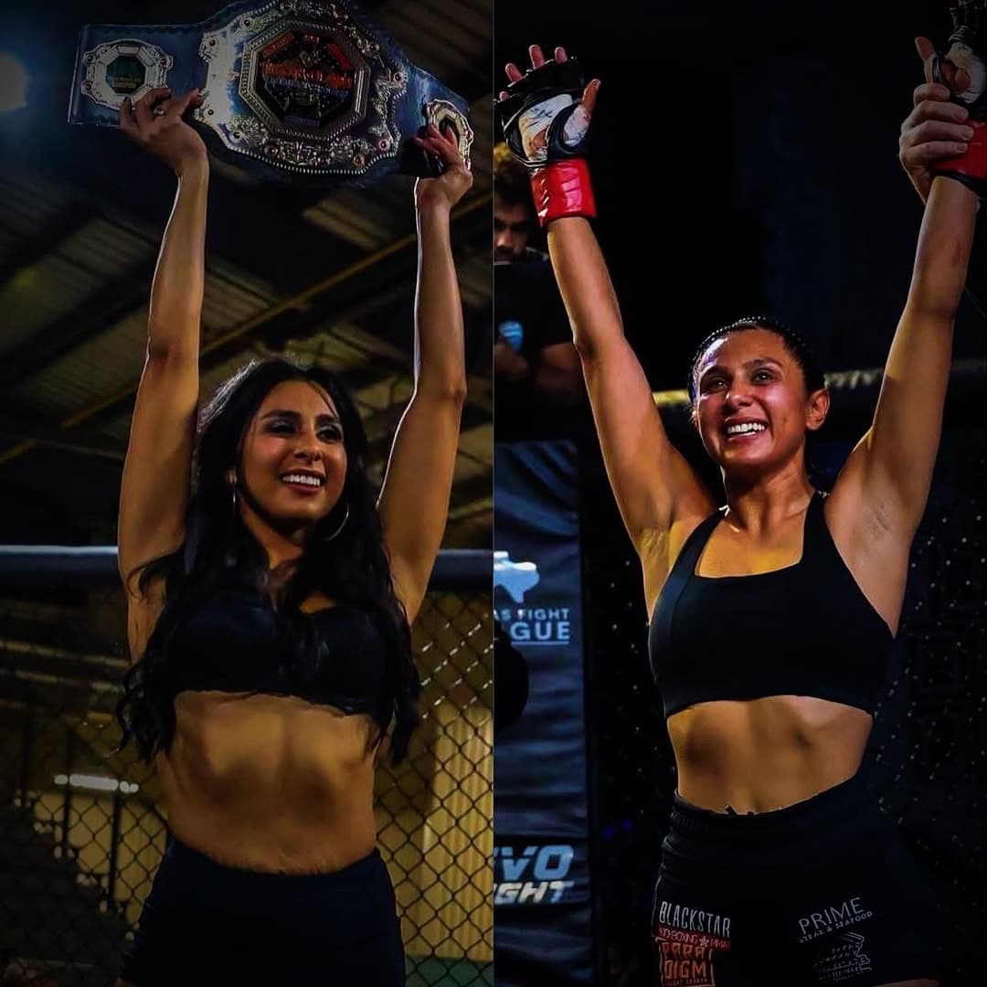 A Blackstar fighter raises both arms in the cage after a win